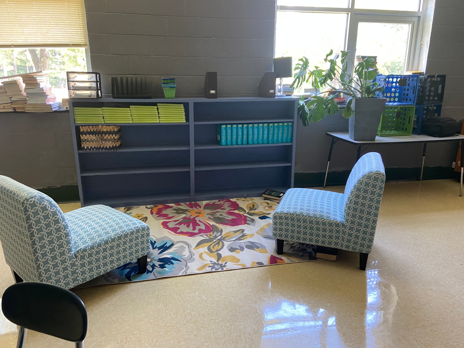 A welcoming classroom reading nook with chairs and bookshelves